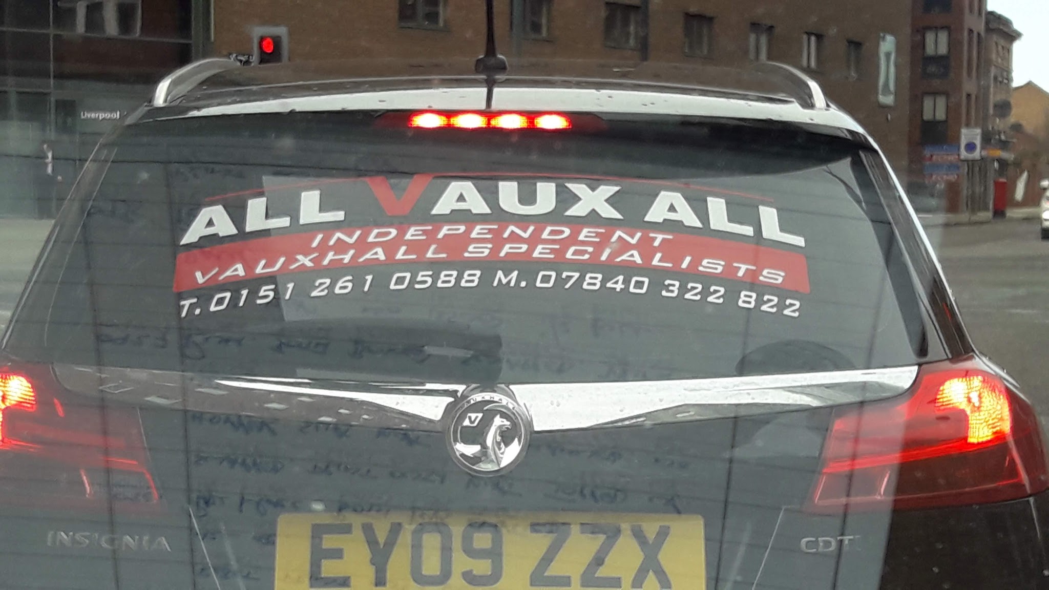 Rear window of a Vauxhall Insignia lettered All Vaux All, Independent Vauxhall Specialists, with both phone numbers